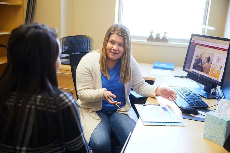 A peer mentor works with a UW-La Crosse student as part of the It Make$ Cents financial literacy program that aims to addresses financial concerns of students that are unique to college life. Photo taken in early 2020.