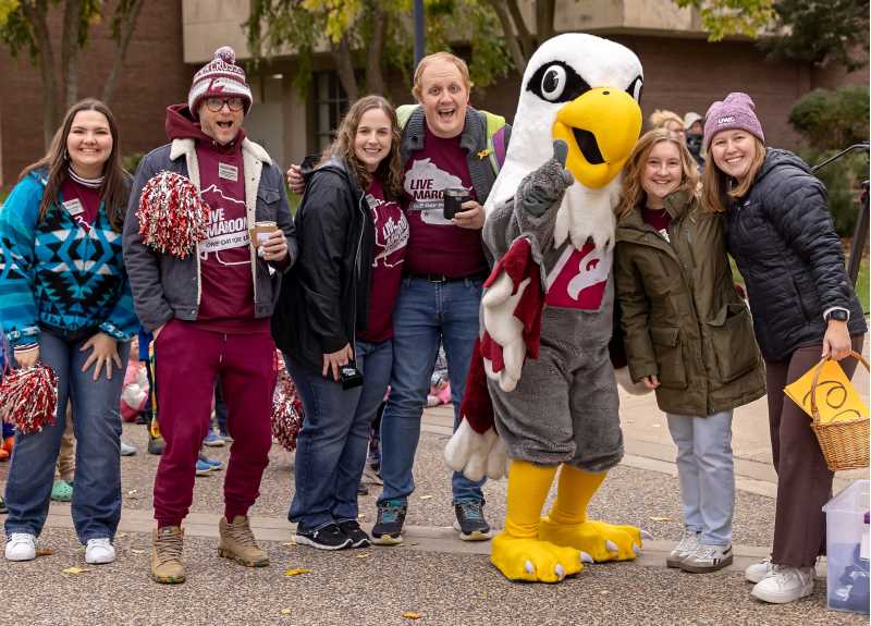 UWL staff members gather with Stryker Eagle at the UWL  Hoeschler Clock Tower during One Day for UWL.
