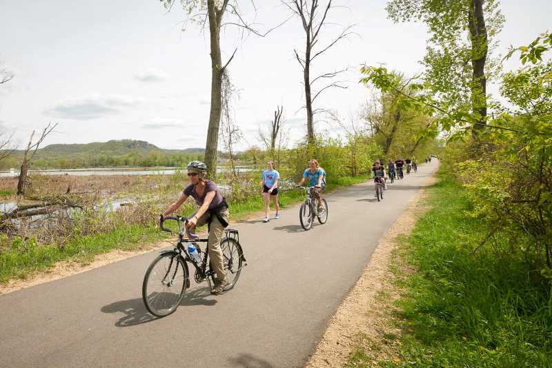 UWL students and staff bike down Grand Crossing Trail through the La Crosse River Marsh.