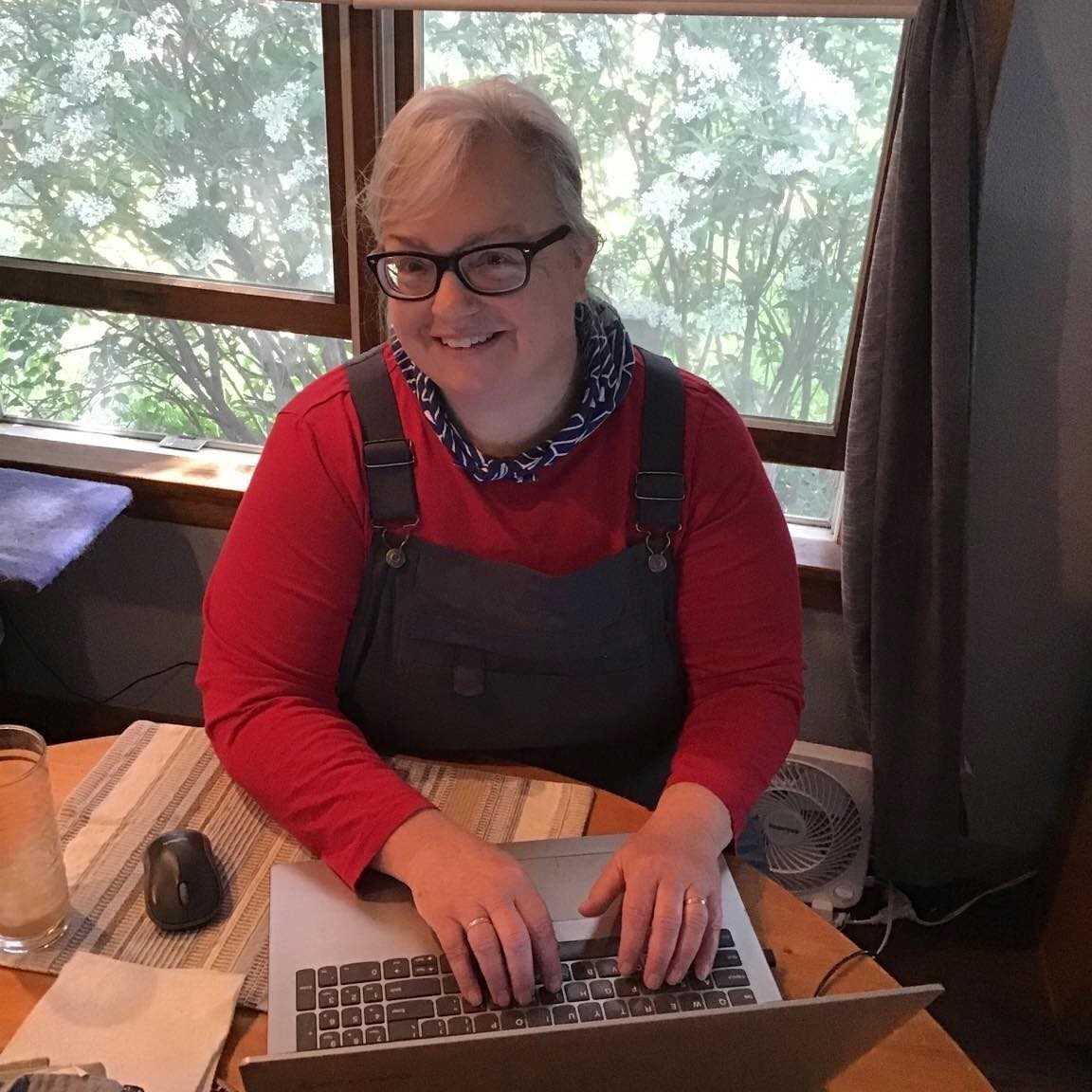 Dr. Crank writing in her dining room.