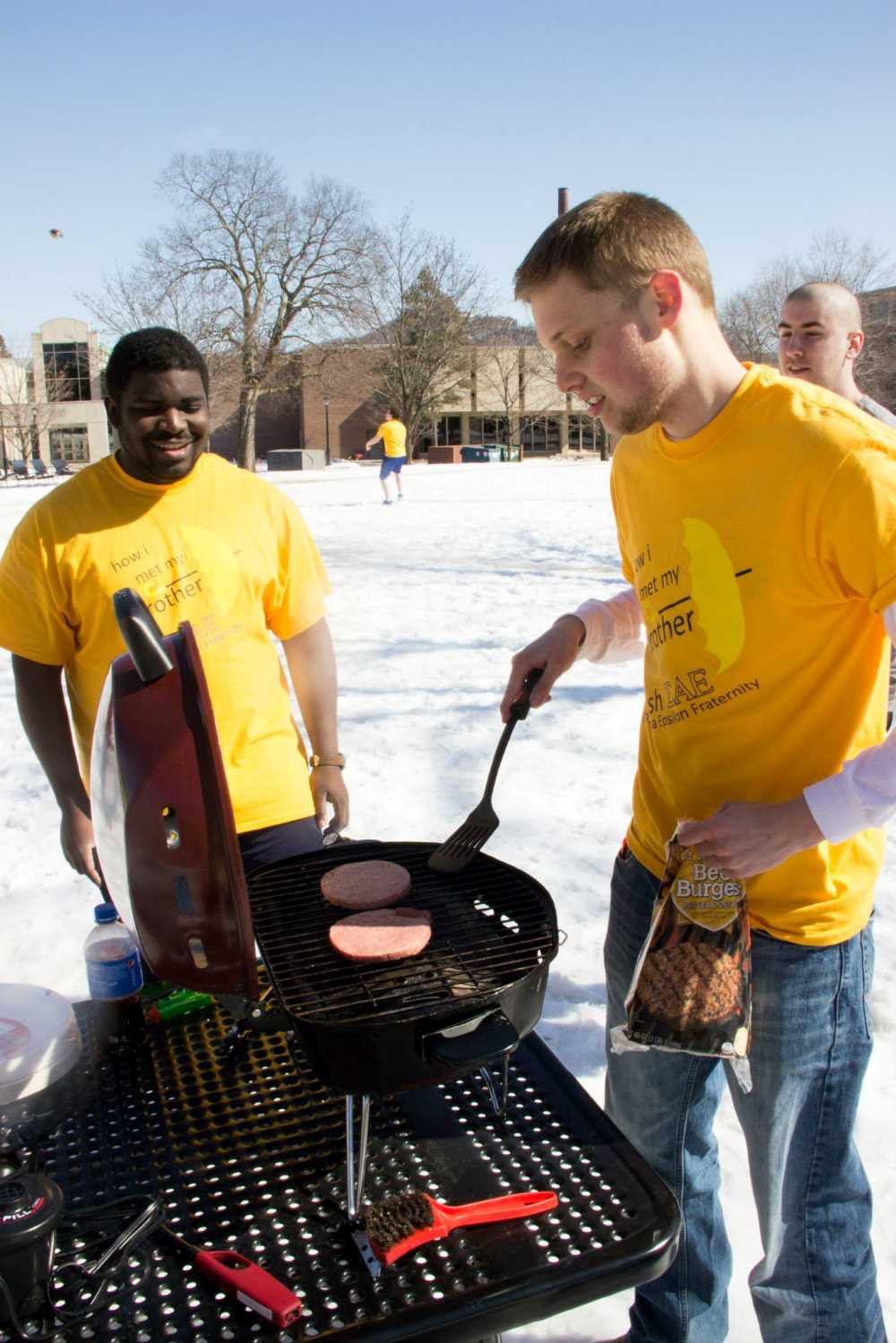 Lamda Chi members grill outside in the snow for their "How I Met Your Mother" brotherhood. 