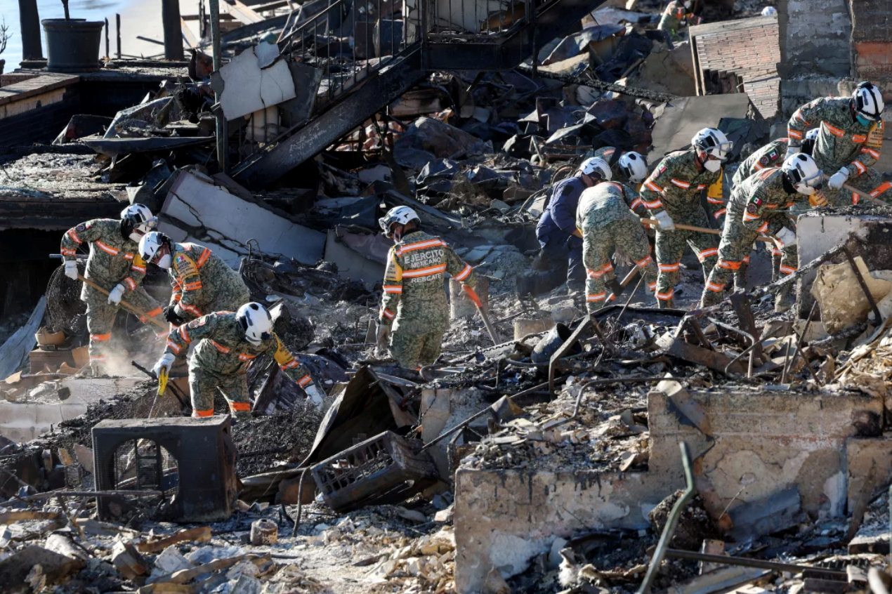 Cleaning out the debris in Palisades. Valerie Macon/AFP via Getty Images