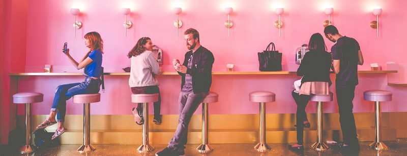 People interacting at a counter, Photo by Jessica Christian on Unsplash