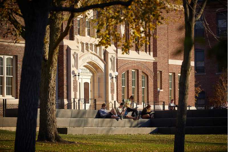 Students study on the patio of Wittich Hall.