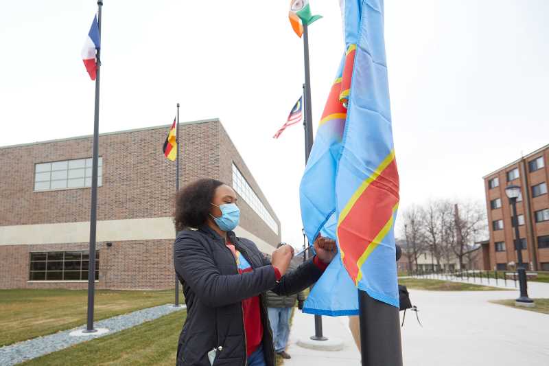 UWL Senior Vanessa Mbuyi Kaja raises the flag of the Democratic Republic of Congo for the first time on campus during a December 2020 ceremony. The flag’s addition to the group of international flags on Badger Street was among the many accomplishments for the International Education & Engagement Office, which has received the state’s 2021 Hong Rost Memorial Leadership Award for Innovation in International Education Student Services.
