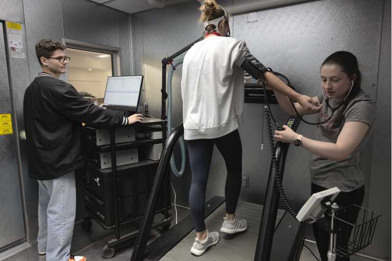 From left, UWL students Nik Carpenter, a research student and graduate teaching assistant; and students Gwen Stovall and Amanda Bratsch are measuring sport performance in the environmental chamber where specific temperature and humidity can be tightly controlled. 