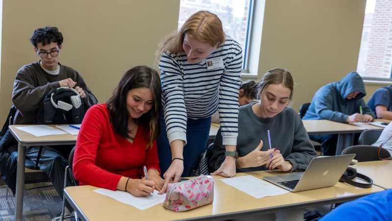 Caitlin Herminath (center), a senior majoring in mathematics education, is one of a handful of students who have benefitted from UWL's new Math Education Teaching Assistant Program. The program allows aspiring educators to gain experience co-leading a general education math course that closely mirrors what they will see in an actual high school. 