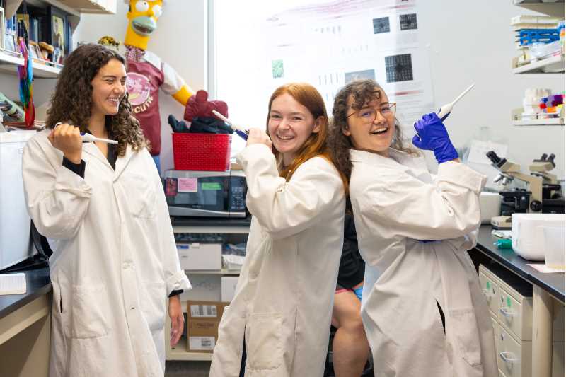 From left, Rachel Hohensee, Evelyn Norton and Emjay Hilliker pose for a picture in their lab.  