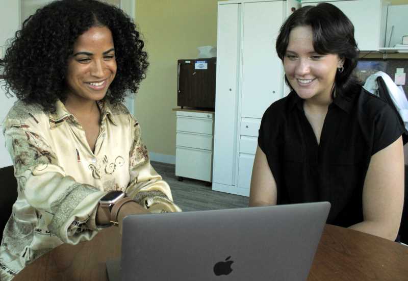 UW-La Crosse student Ellie Schneider, right, works with her mentor Alexis N. Peña, cofounder of the startup company Good Fibes, at Argonne National Laboratory. The two are workshopping a literature review on chemical and enzymatic cross-linking of proteins in hopes of applying these techniques for textile applications. 