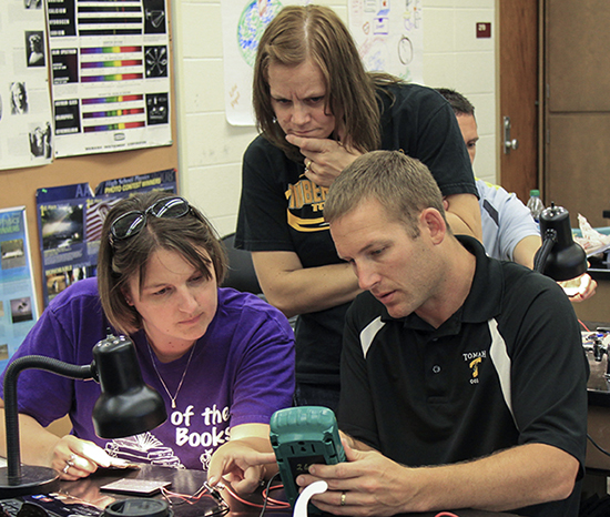 K-12 teachers using small, calculator-like device to understand solar energy. 