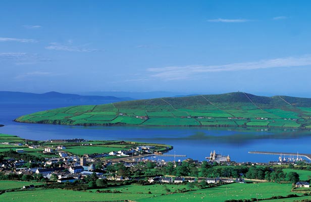 Image of blue waters surrounding a Green peninsula or island in Galway, Ireland. 