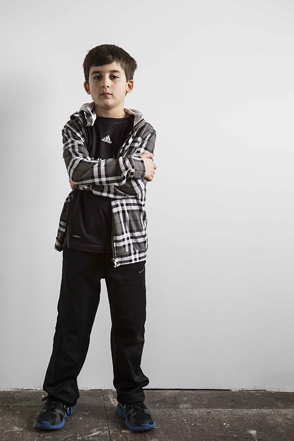 image of child standing arms crossed