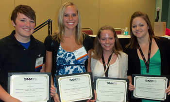 Four students with awards. 