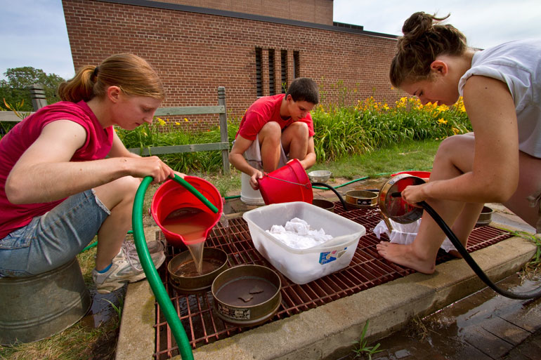 Students floating soil samples. 