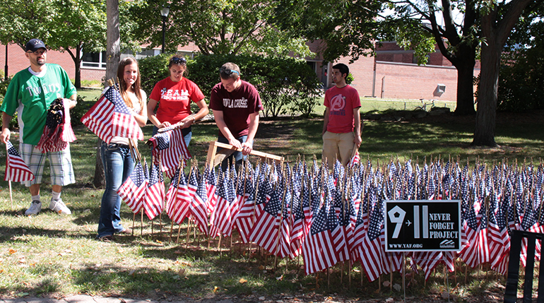 Photo of students putting out flags. 