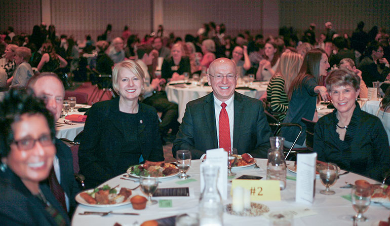 Ray Cross seated at a table with other guests.