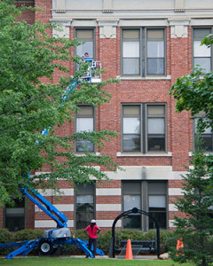 Workers cleaning windows at Graff Main Hall.