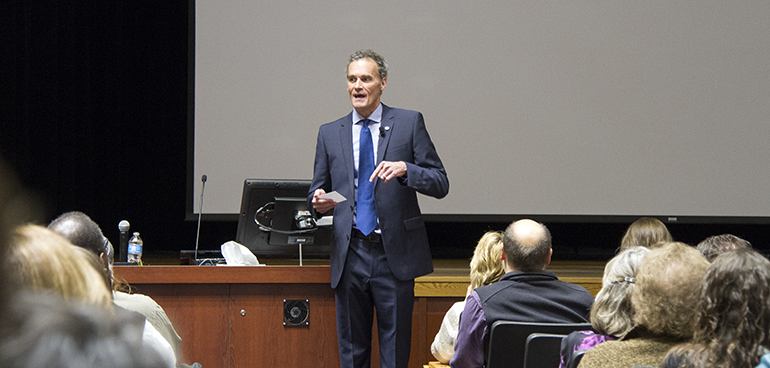 Image of Gow speaking in front of the room.