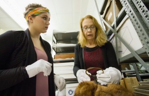 Image of Ariel Recker looking at an artifact with Peggy Derrick.