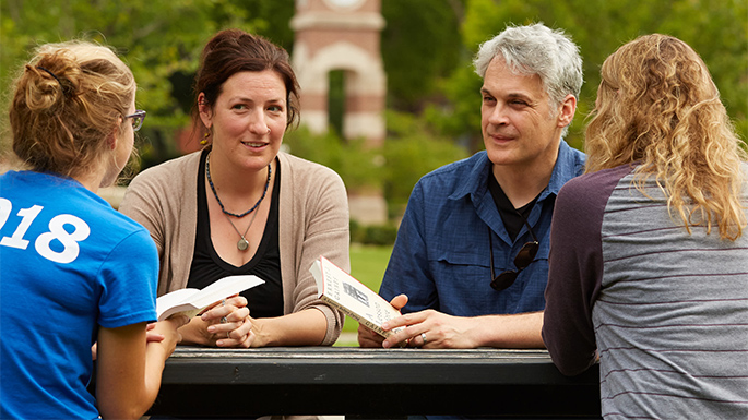 UWL English Department assistant professors, Kate Parker, left, and Bryan Koop discuss plans for the upcoming “Big Read” featuring Ernest J. Gaines’ novel, “A Lesson Before Dying.” Students in Kopp’s upper-level English course were involved in the Big Read grant-writing process.