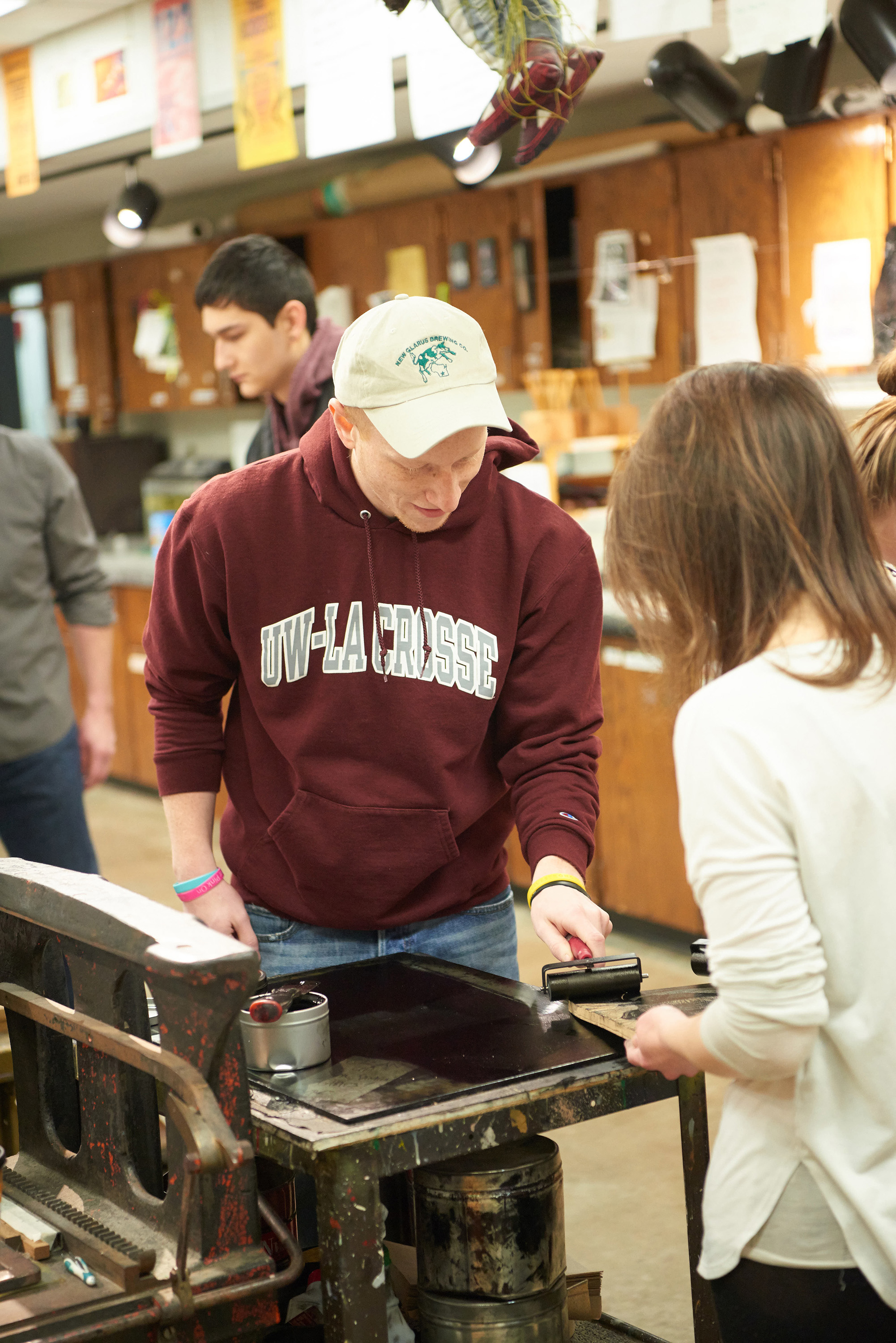 UWL printmaking students roll ink on a wood block. Participants were encouraged to bring an article of clothing and have it printed by students with select UWL “Printfool” original artwork.