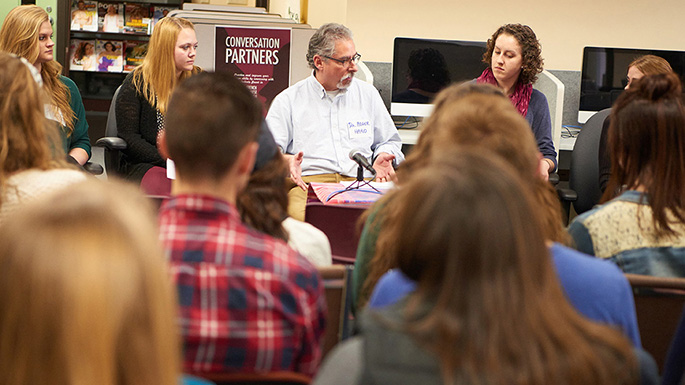 Biology professor Roger Haro with 7 students sharing stories about languages