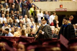 Nick Nicklaus carries the mace at a Spring 2016 Commencement ceremony. He is retiring this summer.