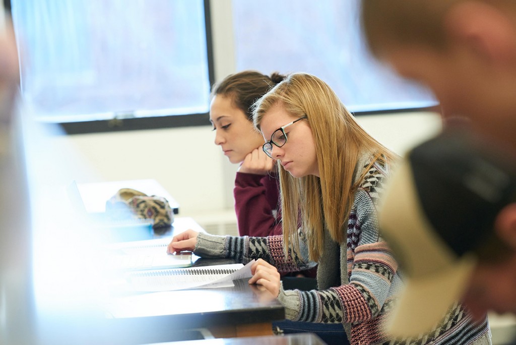 Activity; Reading; Research; Studying; Buildings; Cowley; Location; Inside; Classroom; Objects; notepad; People; Woman Women; Student Students; Time/Weather; day; sunny; Type of Photography; Candid; UWL UW-L UW-La Crosse University of Wisconsin-La Crosse; Winter; January