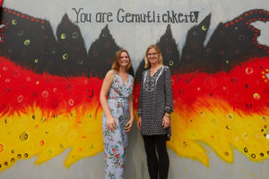 Murphy and Williams pose in front of the butterfly mural.