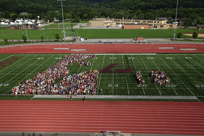 Photo of football field with students. 