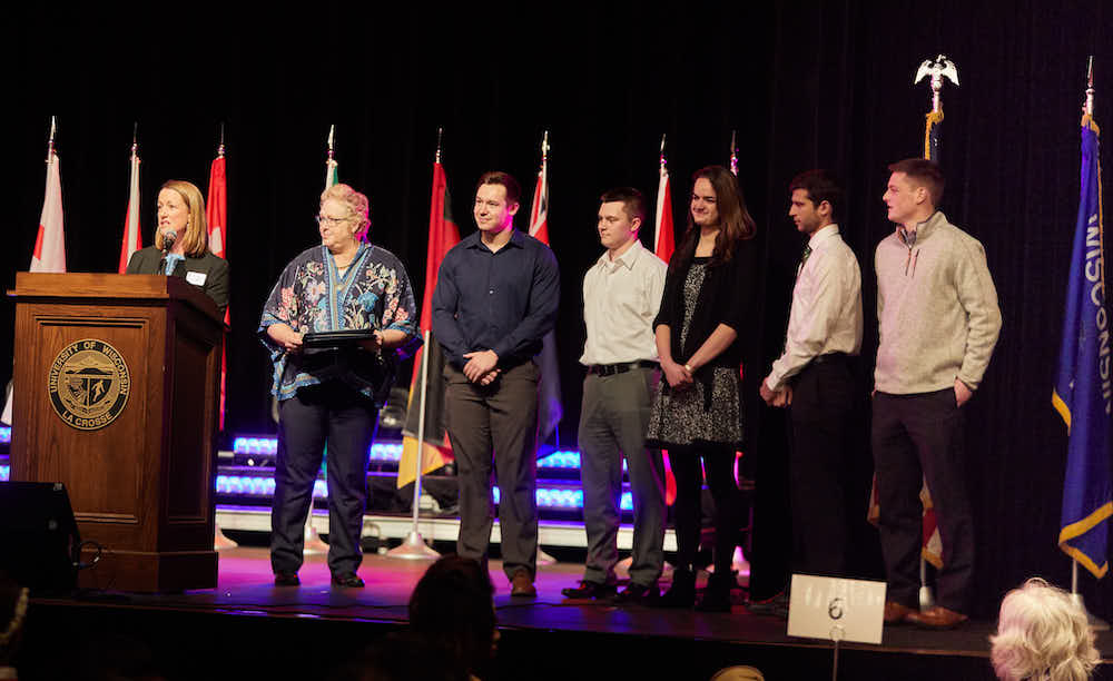 Sean Anderson standing with other students at the International Banquet where he is receiving an award. 