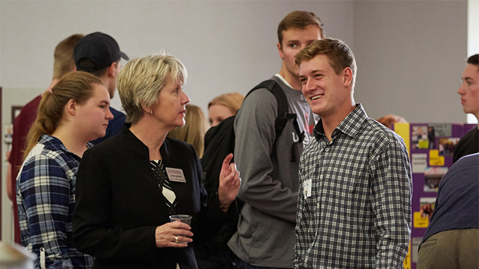 UWL Junior and Accounting Major Jon Barnes talks with CBA Dean Laura Milner during the annual CBA Meet & Greet. Barnes says the CBA has given him many opportunities to lead, volunteer and be part of a team. 