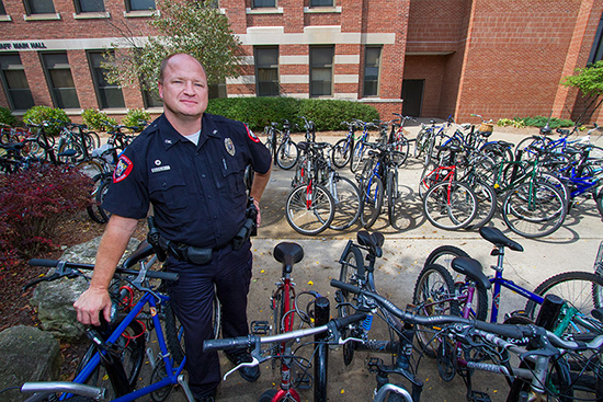 Officer Dave Pehl stands by bikes on campus.