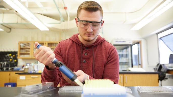 Image of Jason conducting an experiment using a technical instrument.