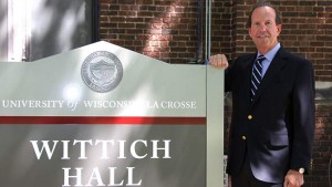 Image of Bruce May standing by sign that says Wittich Hall.