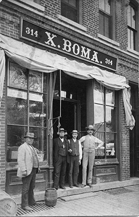 Portrait of men in front of building. 