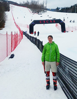 Cody Anderson stands in front of the finish line at the USCSA. He was the only male skier from Wisconsin to qualify this year.