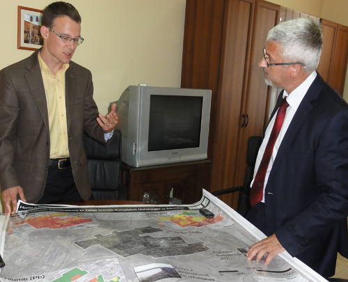 Ryan Perroy presents a map of soil contamination that he created to the Albanian Deputy Minister of the Environment.