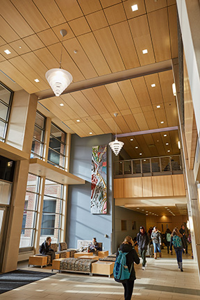 A combination of high efficiency lights and natural light have reduced energy consumption in Centennial Hall, UWL’s academic building. In this picture the wall mounted sconce lights high on the ceiling and the recessed ceiling lights in the two story gathering area are high intensity discharge (HID). This type of lighting allows a large area to be lit while consuming less energy than a fluorescent or incandescent lamp would.