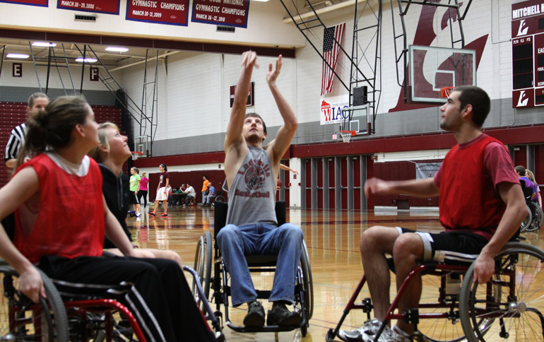 Students in wheelchairs playing basketball.