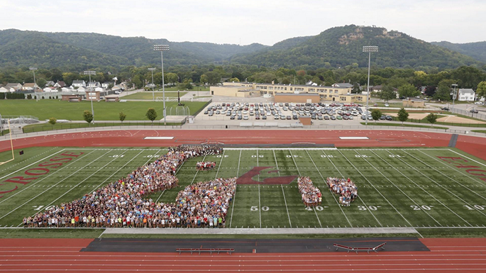 image of students forming an Eagle L and the number 19 on the football field.