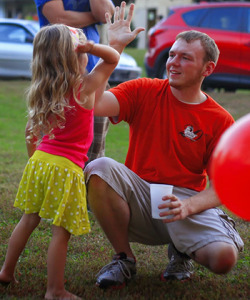 Image of Tim Good giving a high five to a child at the festival.