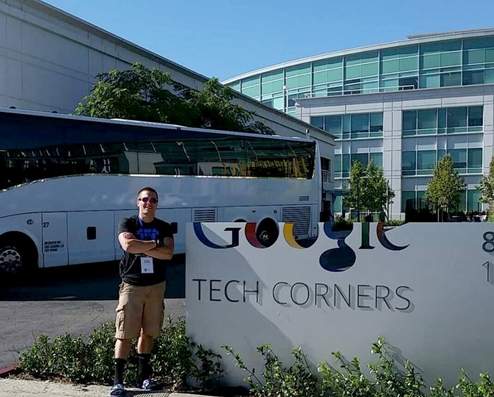 Nathan McCourt, UWL student, standing near a sign that says "Google Tech Corners."