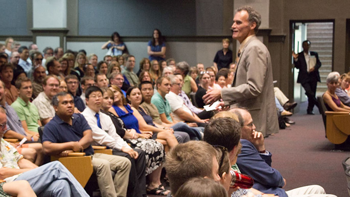 Image of Joe Gow speaking in Graff Main Hall Auditorium.