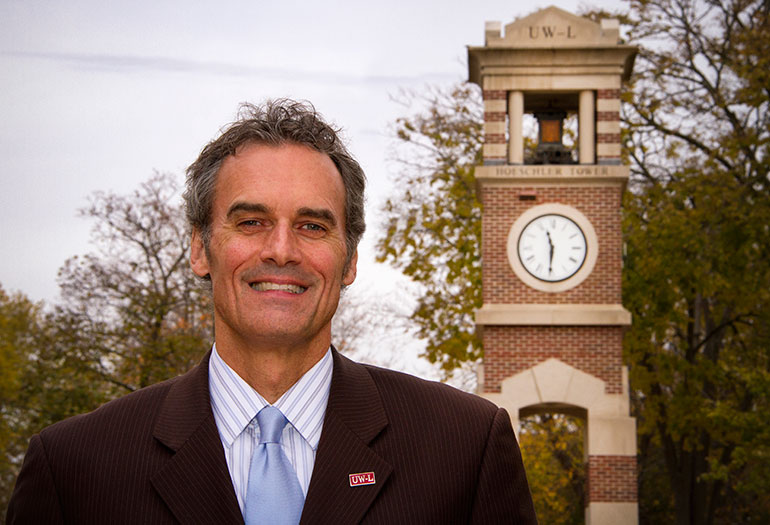Photo of Chancellor Joe Gow in front of Hoeschler Tower. 