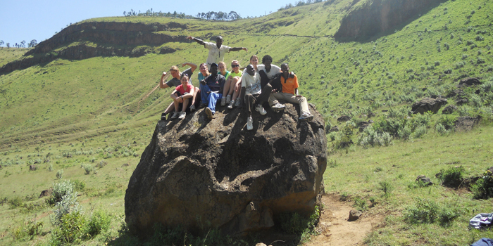 Group sitting on a rock at Mendengai Crater