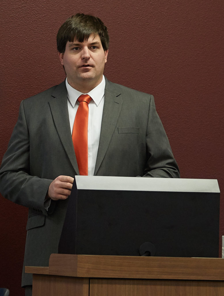 Adam Hoffer standing behind a podium.