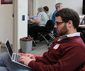 image of David Mindel typing on his laptop. 