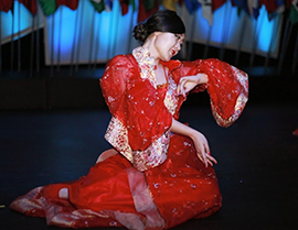 UW-L international student Xinyue Zheng holding a dance pose at the International Banquet. 