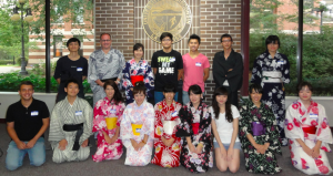 Image of Japanese students in their traditional dress posing for a picture with several UW-L students.